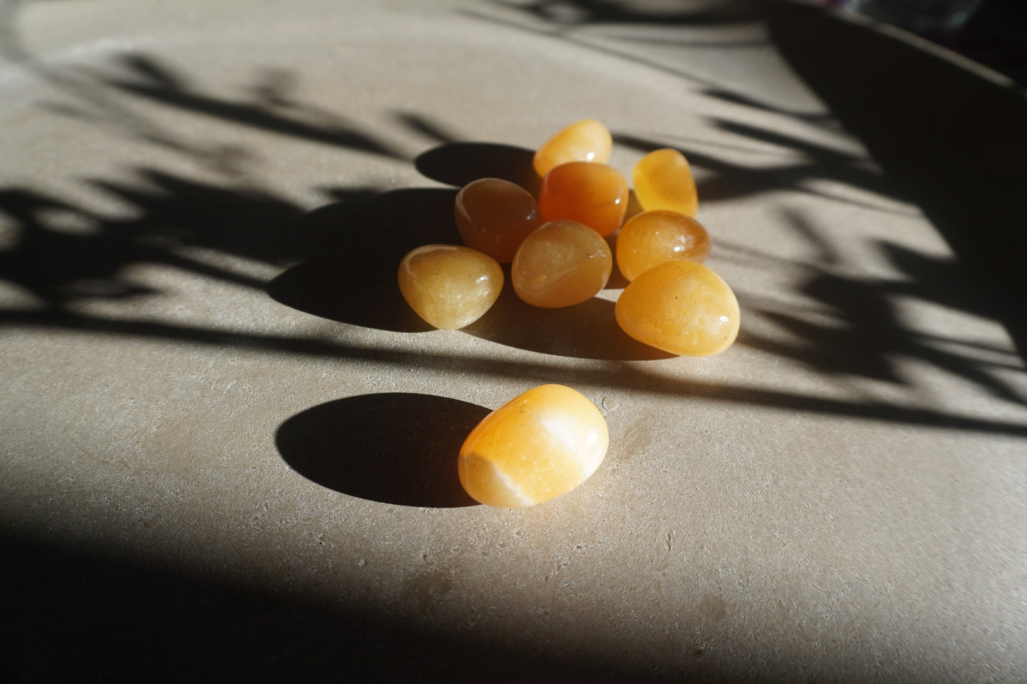 Orangencalcit Trommelstein